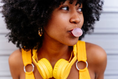 Close-up of young woman holding yellow