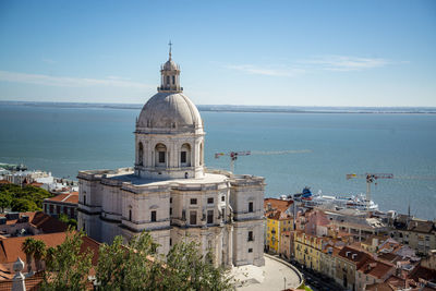 High angle view of townscape by sea against sky