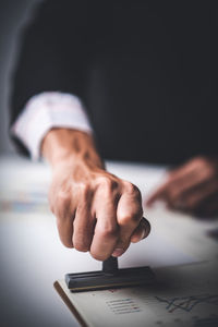 Midsection of man working on table