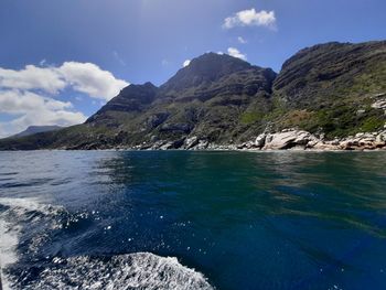 Scenic view of sea and mountains against sky