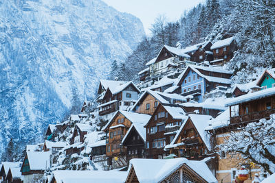 Snow covered residential district by mountain