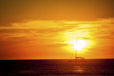 Scenic view of sea against orange sky