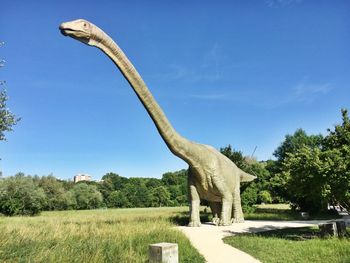 View of statue on field against sky