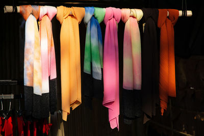 Colorful scarfs hanging on rod for sale