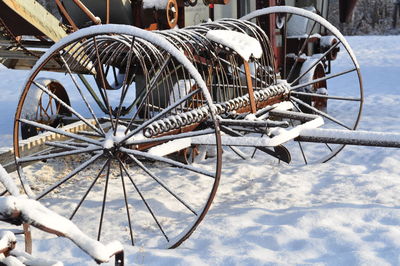 Wagon wheel on snow covered field