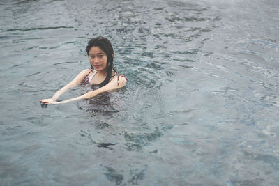 Portrait of young woman in sea