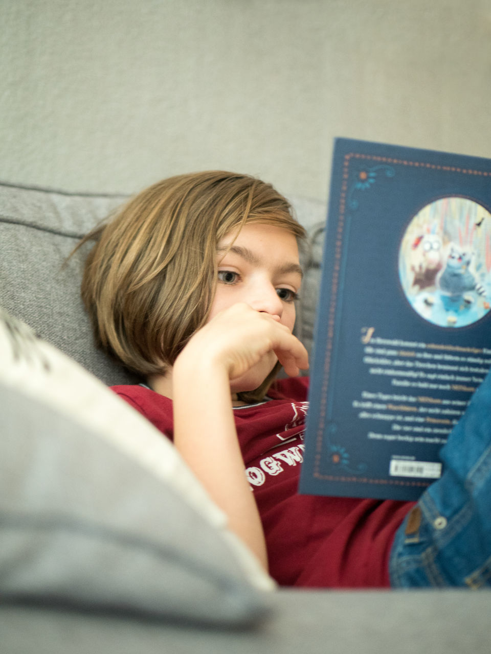 PORTRAIT OF GIRL HOLDING BOOK ON TABLE