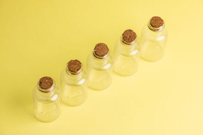 High angle view of glasses on table against yellow background