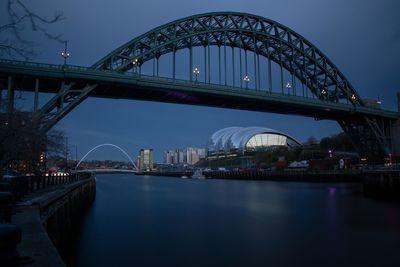 View of bridge over river at night