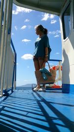 Full length of woman standing on boat deck