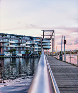 Bridge over river against sky during sunset