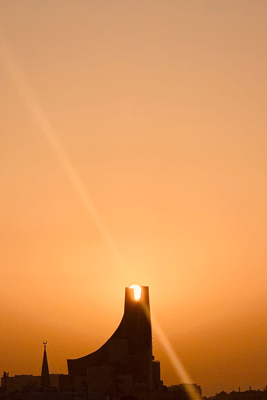 SILHOUETTE BUILDINGS AGAINST SKY DURING SUNSET