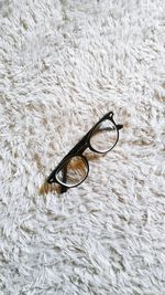 High angle view of eyeglasses on rug