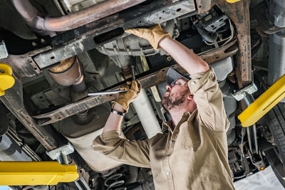 Midsection of man working at workshop