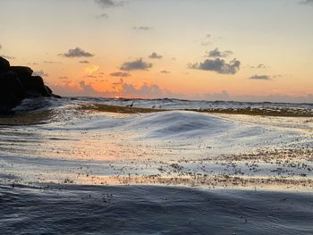 Scenic view of beach against sky during sunset