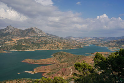 Scenic view of sea and mountains against sky