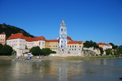 Buildings in town against clear sky