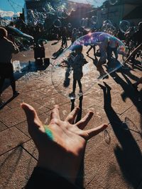 High angle view of people playing on street in city
