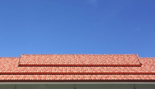 Low angle view of house roof against clear sky