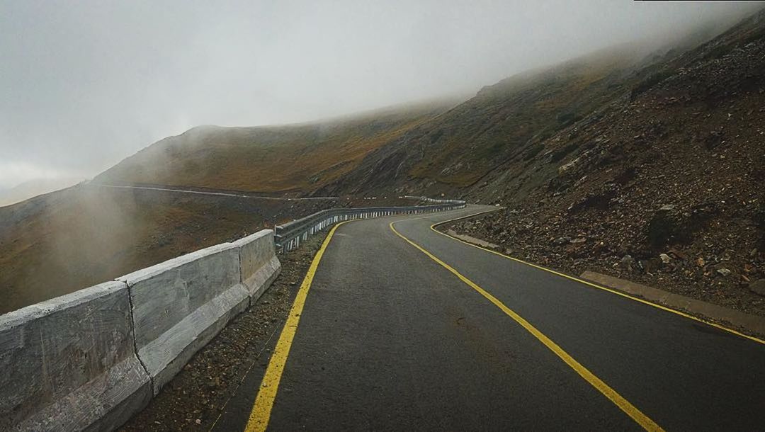 AERIAL VIEW OF ROAD ON MOUNTAIN AGAINST SKY