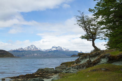 Scenic view of sea and mountains against sky