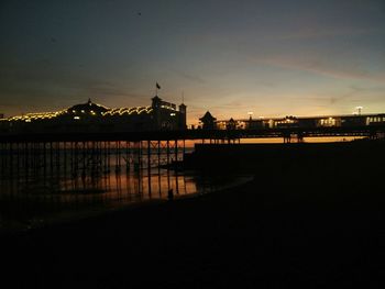 View of illuminated built structures at sunset