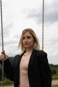 Portrait of woman standing against sky