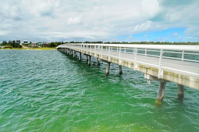 Pier over sea against sky