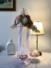 Roses in glass vase on table