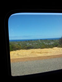 Scenic view of landscape seen through car window