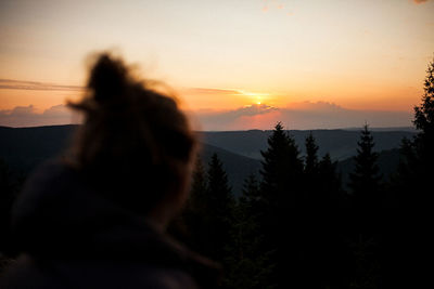 Silhouette woman against sky during sunset