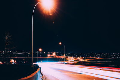 Light trails on road in city at night