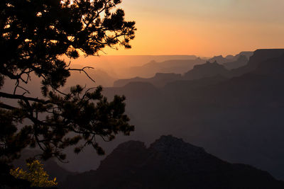 Scenic view of silhouette mountains against sky at sunset