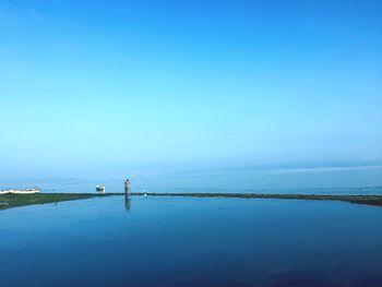 Scenic view of sea against clear blue sky