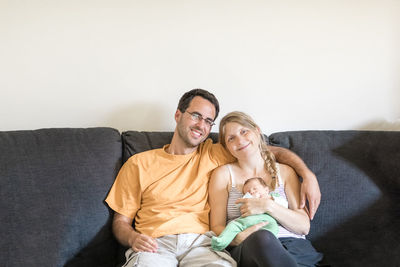 Family sitting on sofa