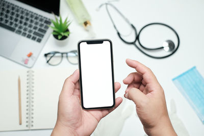 Midsection of man using mobile phone