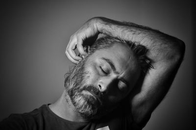 Close-up portrait of young man against white background