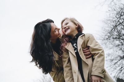 Cheerful mother and daughter enjoying in park