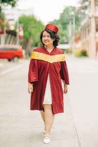 Portrait of young woman standing on street