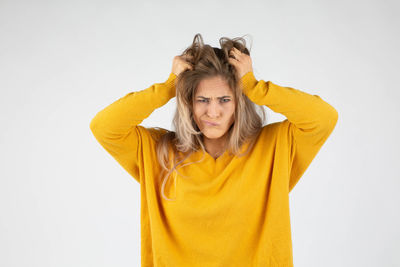 Portrait of a beautiful young woman against white background