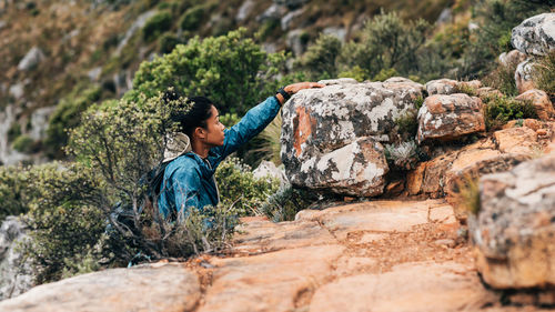 Rear view of man standing on rock