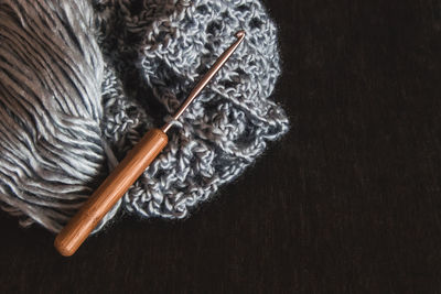 Close-up of cropped wool yarn and needle