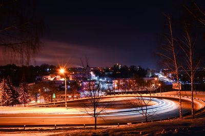 High angle view of light trails on road at night