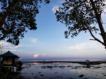 Scenic view of beach by sea against sky