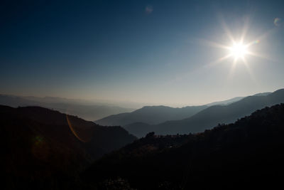 Scenic view of silhouette mountains against sky during sunset