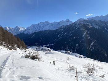 Scenic view of snow covered mountains against sky