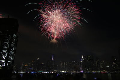 Low angle view of firework display at night