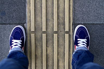 Low section of man standing on walkway