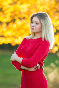 Thoughtful beautiful young woman standing outdoors