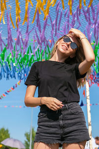 Young woman sitting on festival. gen z girl enjoying outdoors, expressing positive emotions having 